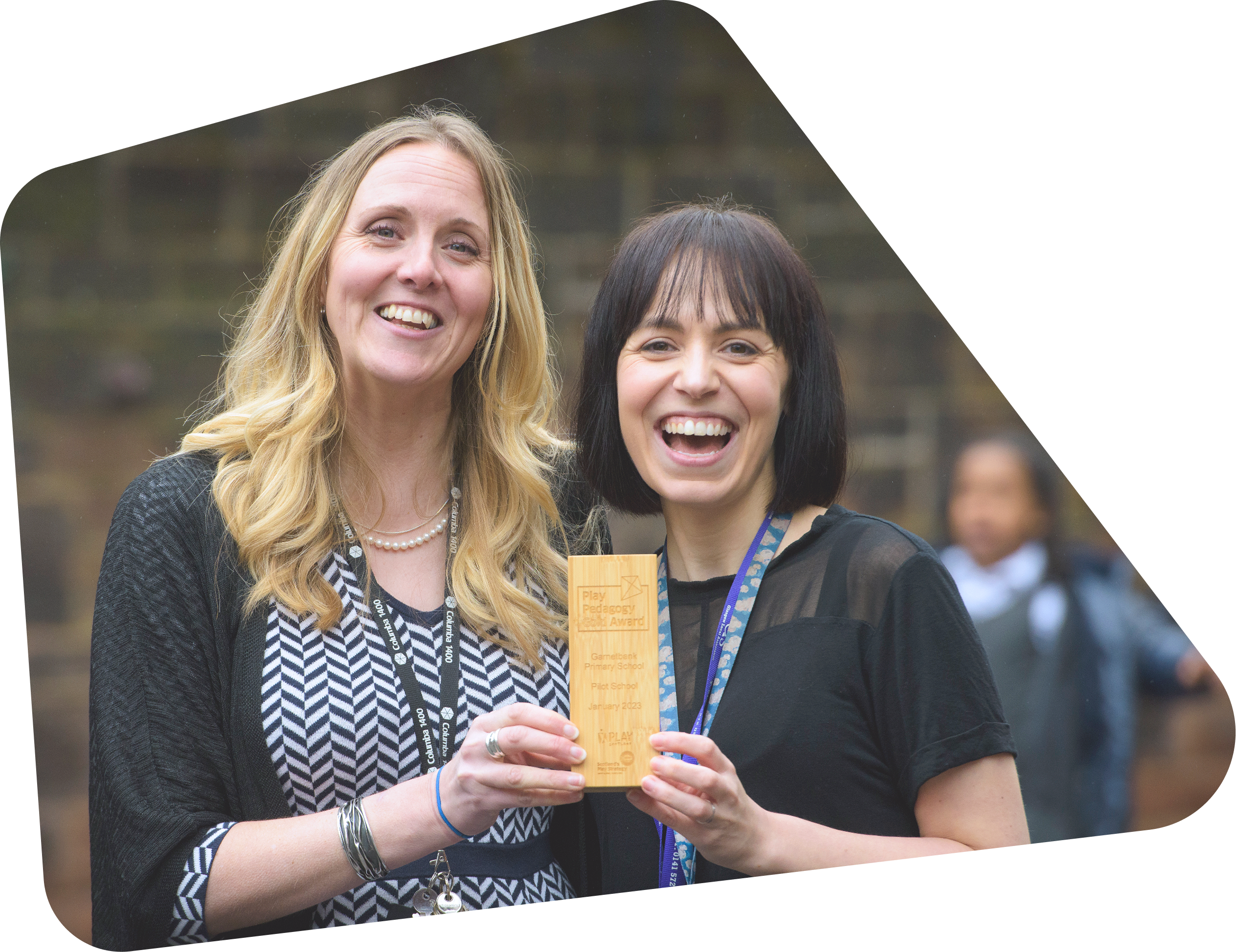 Two teachers holding Play Pedagogy Award